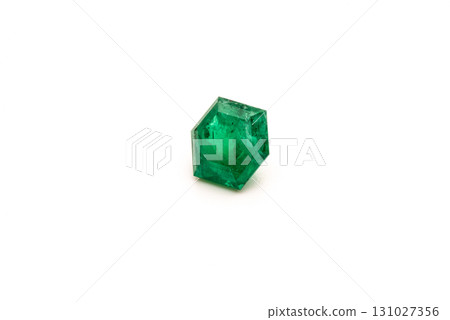 A green gemstone is sitting on a white background A green gemstone is sitting on a white background 131027356