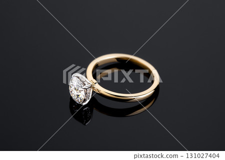 A gold and diamond ring with a diamond in the center A gold and diamond ring with a diamond in the center 131027404