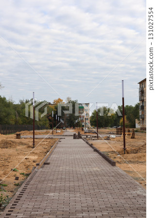 Construction of a New Urban Park: Leveling the Ground and Laying New Sidewalks for a Vibrant Community Space Construction of a New Urban Park: Leveling the Ground and Laying New Sidewalks for a Vibrant Community Space 131027554