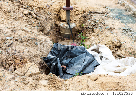 Construction Pit Featuring Newly Installed Urban Streetlight Pole, Highlighting Modern Urban Infrastructure Development and Safety Enhancements 131027556