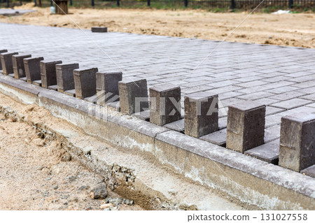 Newly Laid Paving Stones on a Developing Pedestrian Pathway in a Park, Showcasing Modern Urban Design and Natural Surroundings 131027558