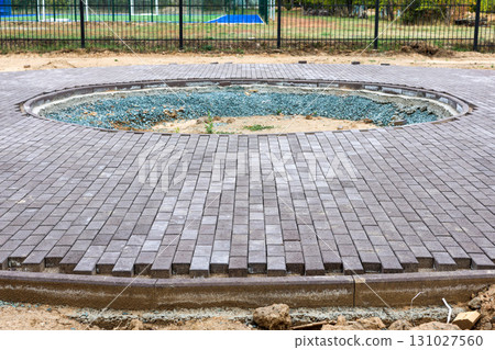 Round Construction Pit on Sidewalk in Newly Developing Park, Showcasing Urban Development and Infrastructure Improvements for Community Spaces 131027560