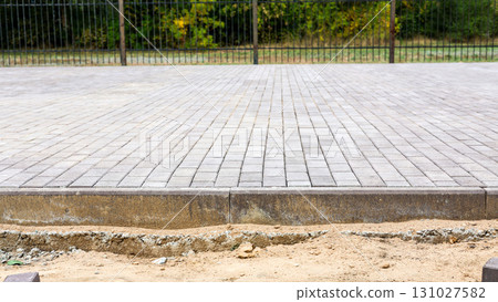 Spacious Park Square Paved with Construction Stones: A Beautifully Designed Outdoor Area for Leisure and Community Activities in Urban Environment 131027582