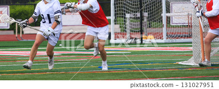 Youth Lacrosse Players in Action on a Turf Field 131027951