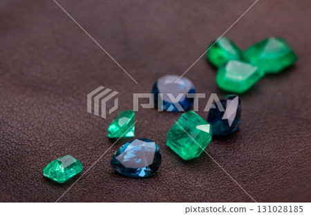 A pile of green and blue gemstones on a dark surface 131028185