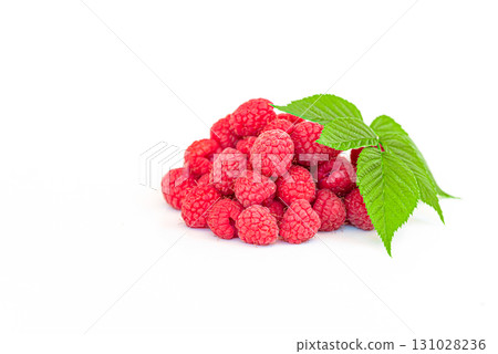 A bunch of red raspberries with a leaf on top A bunch of red raspberries with a leaf on top 131028236