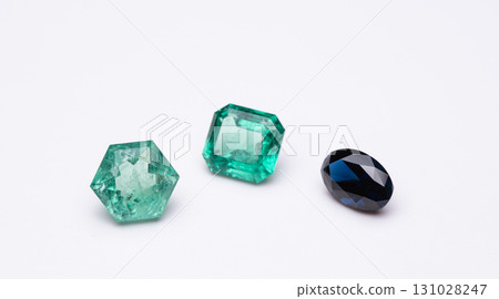 Three different colored gemstones are displayed on a white background Three different colored gemstones are displayed on a white background 131028247