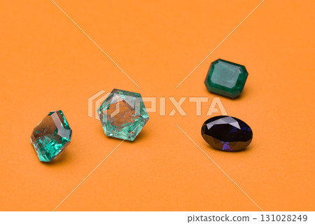 Four different colored gems are displayed on a yellow background Four different colored gems are displayed on a yellow background 131028249