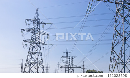 High voltage power transmission lines and steel pylons High voltage power transmission lines and steel pylons 131028898
