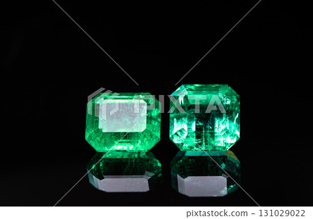 Two green gemstones are displayed on a black background 131029022