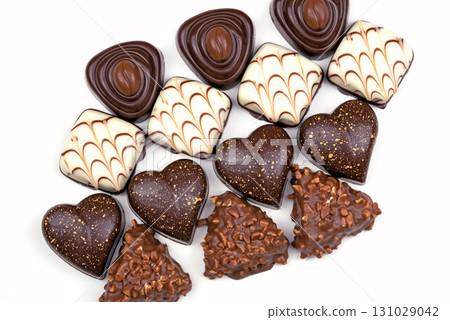 A row of chocolate truffles with hearts on them A row of chocolate truffles with hearts on them 131029042