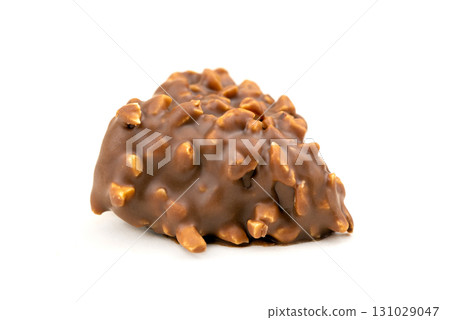 A piece of chocolate with nuts on top A piece of chocolate with nuts on top 131029047