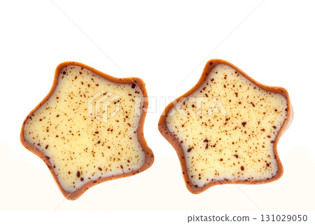 Two chocolate covered star shaped cookies with brown spots Two chocolate covered star shaped cookies with brown spots 131029050