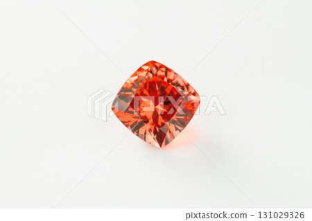A red gemstone sits on a white background A red gemstone sits on a white background 131029326