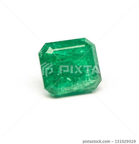 A green gemstone is sitting on a white background 131029329
