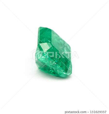 A green gemstone is sitting on a white background 131029337