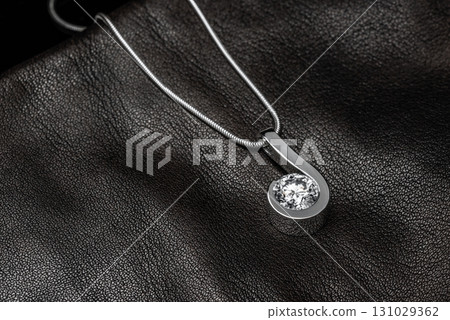 The pendant is shaped like a crescent moon, and the necklace is made of silver 131029362