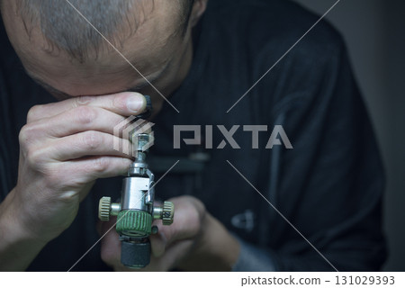 A man is looking through a magnifying glass 131029393