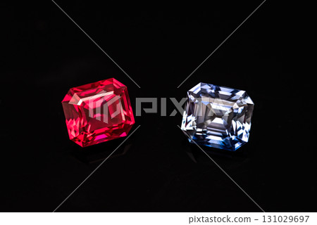 Two gemstones, one red and one blue, are displayed on a black background Two gemstones, one red and one blue, are displayed on a black background 131029697