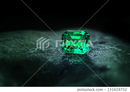 A green gemstone sits on a rock A green gemstone sits on a rock 131029732
