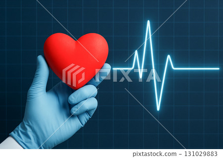 Gloved hand holding heart against heartbeat line on blue background. concept of healthcare, heartbeat monitoring, medical safety. 131029883