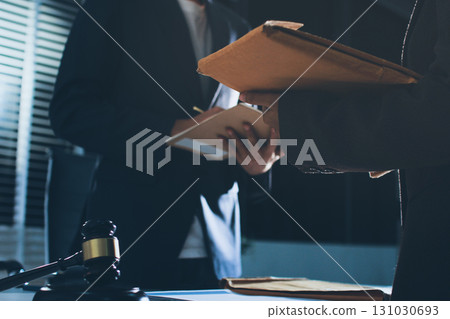 Lawyer explained to the client about the law that must be brought against the court case. Lawyer explained to the client about the law that must be brought against the court case. 131030693