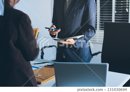 Lawyer explained to the client about the law that must be brought against the court case. Lawyer explained to the client about the law that must be brought against the court case. 131030694