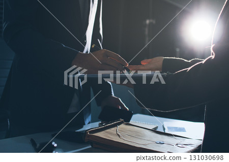 Lawyer explained to the client about the law that must be brought against the court case. Lawyer explained to the client about the law that must be brought against the court case. 131030698