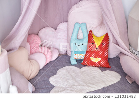 Cozy children s playroom with plush pillows and soft toys in pastel colors 131031488