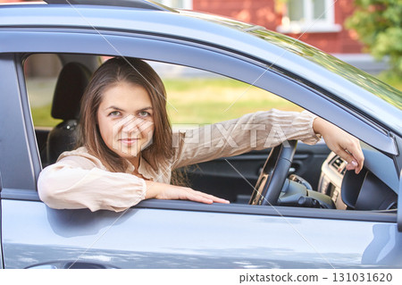 Young caucasian female smiling in car driver seat on sunny day Young caucasian female smiling in car driver seat on sunny day 131031620