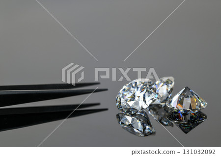A diamond is on a table with a diamond tester A diamond is on a table with a diamond tester 131032092