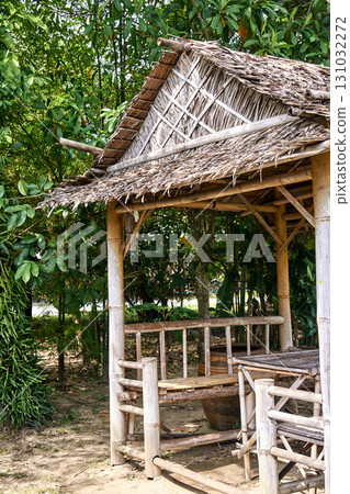 Rustic bamboo hut surrounded by lush greenery in a serene tropical setting Rustic bamboo hut surrounded by lush greenery in a serene tropical setting 131032272