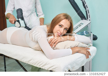 Young caucasian female receiving relaxing body contouring treatment at spa Young caucasian female receiving relaxing body contouring treatment at spa 131032427