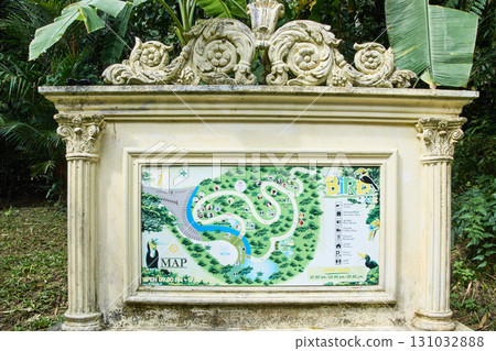 Ornate stone sign with botanical garden map surrounded by lush greenery Ornate stone sign with botanical garden map surrounded by lush greenery 131032888
