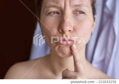 Thoughtful caucasian adult female expressing contemplation with finger on chin 131033250