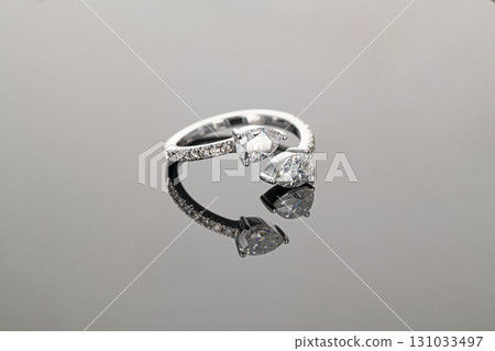 A ring with two diamonds and a diamond band 131033497