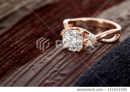 A gold and diamond ring with a white center stone A gold and diamond ring with a white center stone 131033500