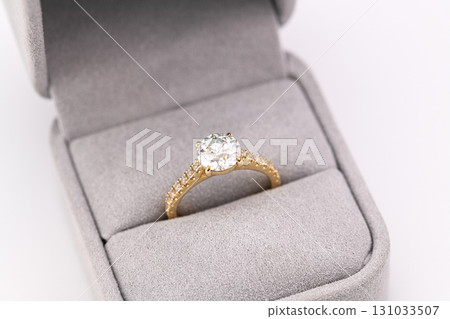 A gold and diamond ring is in a box A gold and diamond ring is in a box 131033507