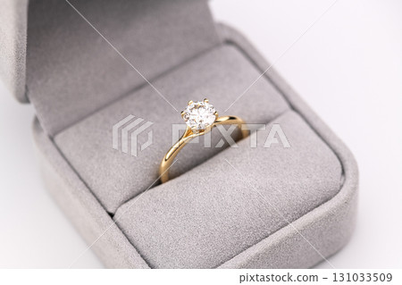 A gold and white diamond ring is in a box A gold and white diamond ring is in a box 131033509