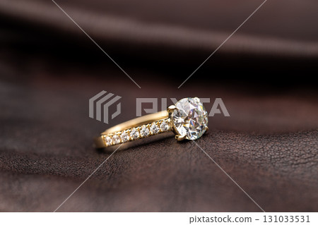 A gold and diamond ring with a band of diamonds 131033531