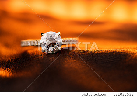 A diamond ring is on a table 131033532