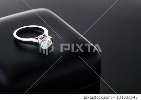 A diamond ring is sitting on a black box 131033548