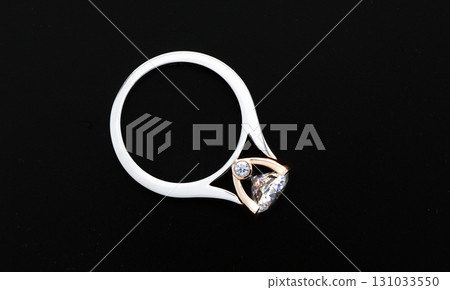 A ring with a diamond and gold band 131033550