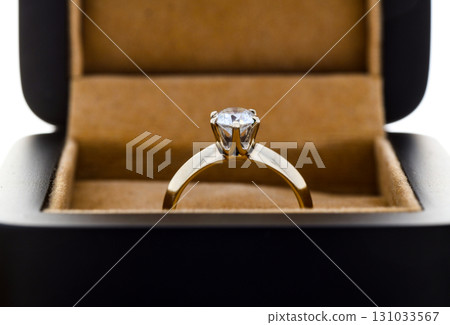 A gold and diamond ring is in a box A gold and diamond ring is in a box 131033567
