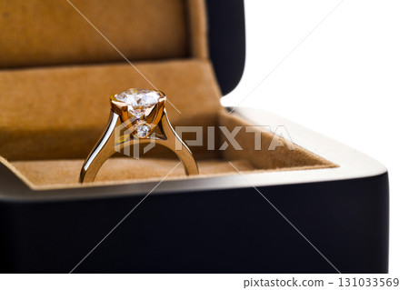 A gold and diamond ring is in a box 131033569