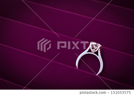 A diamond ring is on a purple background A diamond ring is on a purple background 131033575