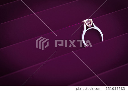A ring is on display on a purple background A ring is on display on a purple background 131033583
