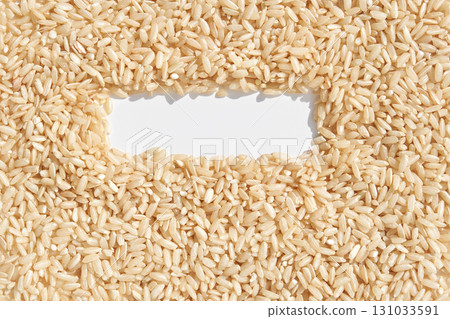 Brown rice grains forming a rectangular frame on white background Brown rice grains forming a rectangular frame on white background 131033591