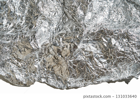 Close-up of crumpled aluminum foil texture with reflective silver surface Close-up of crumpled aluminum foil texture with reflective silver surface 131033640