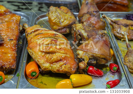 pork shank with appetizing crust and vegetables peppers selective focus 131033908